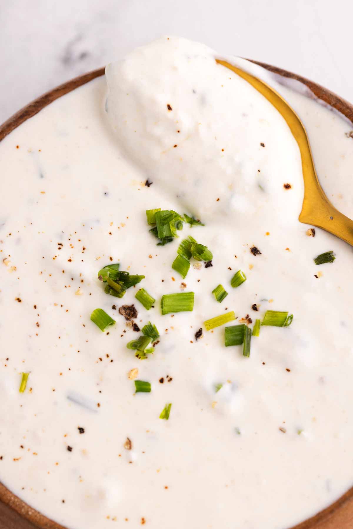 spooning horseradish sauce from a bowl