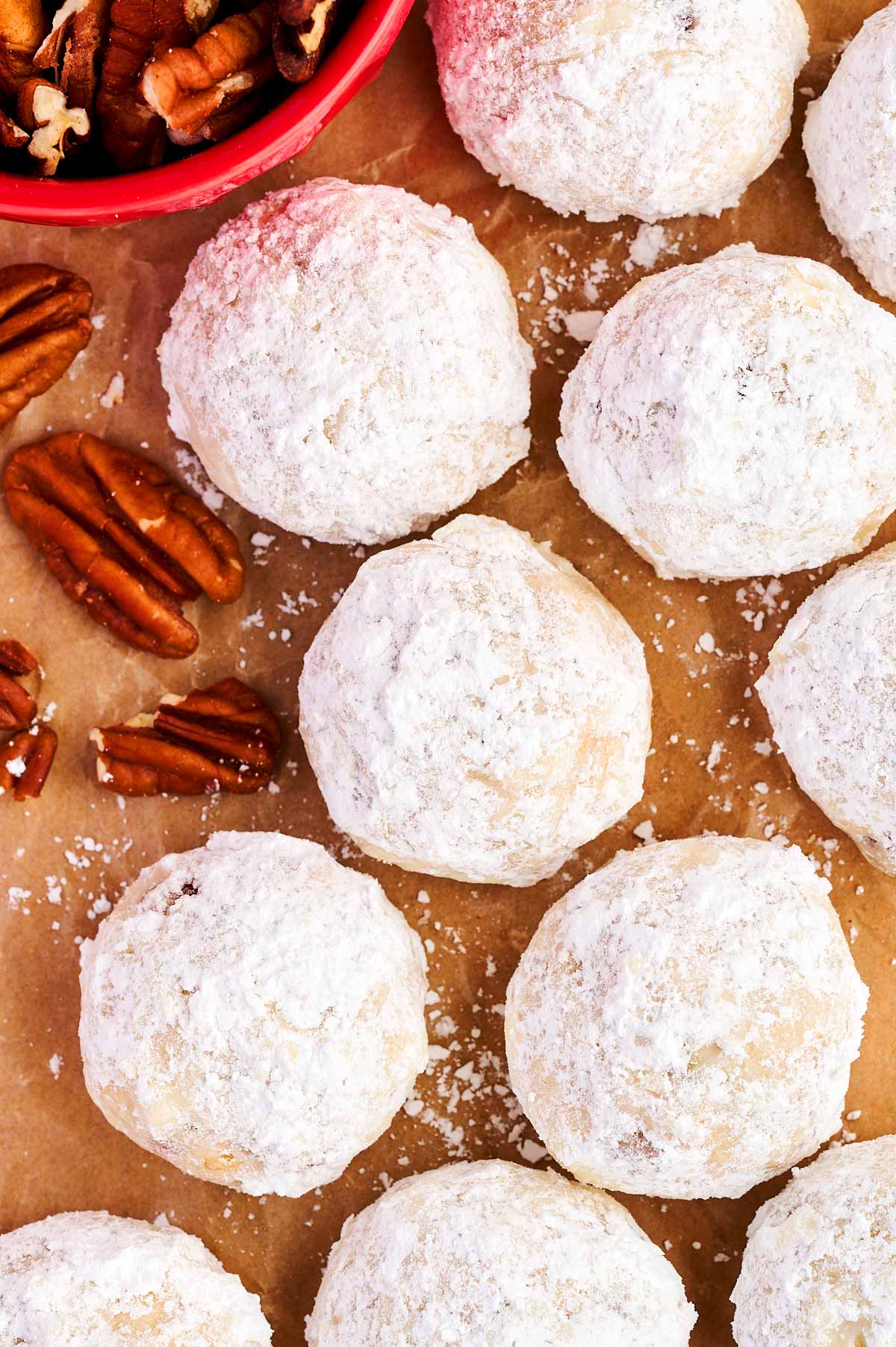 Snowball cookies on baking parchment.