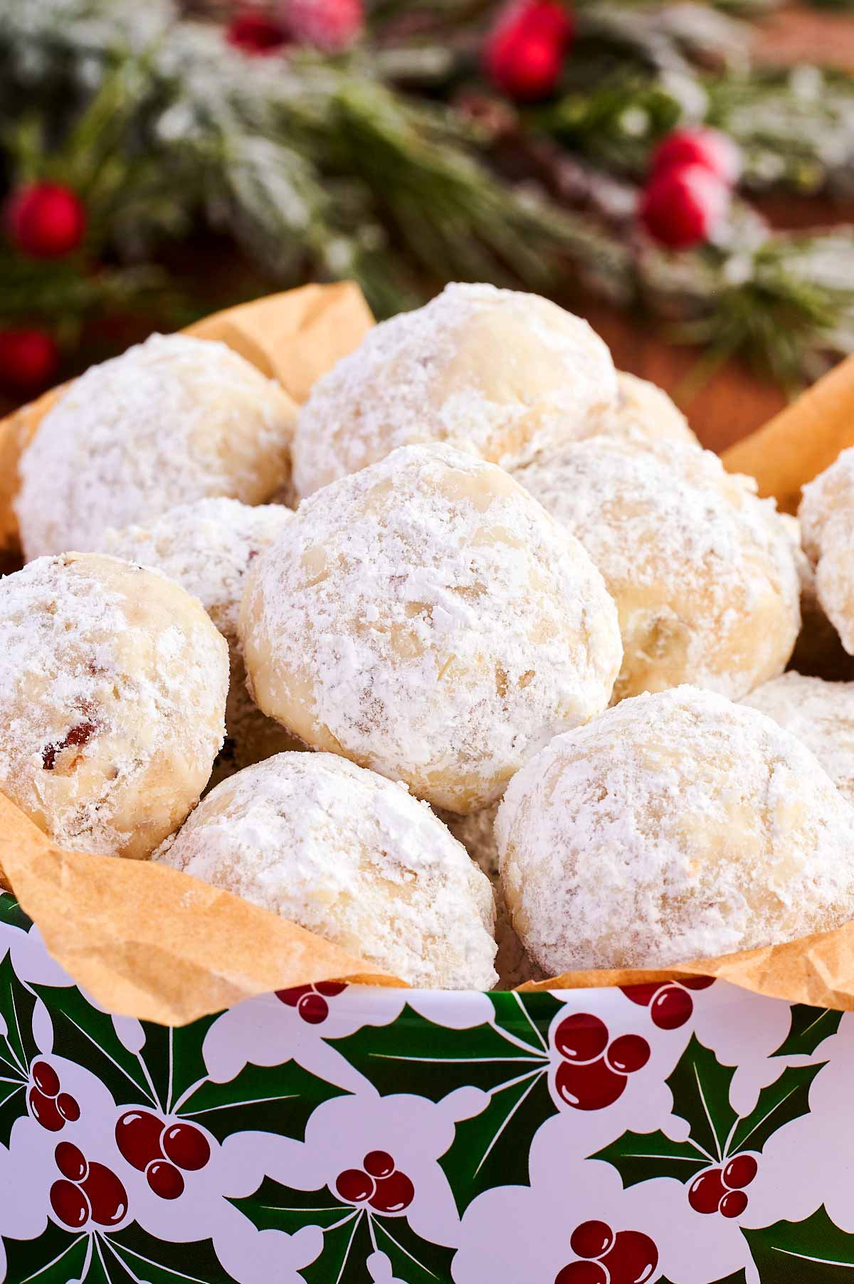 A cookie tin full of Snowball Cookies.