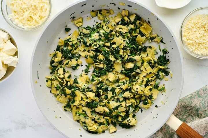 cooking spinach and garlic in a skillet