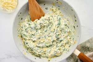 stirring spinach artichoke dip