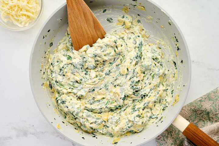 stirring spinach artichoke dip