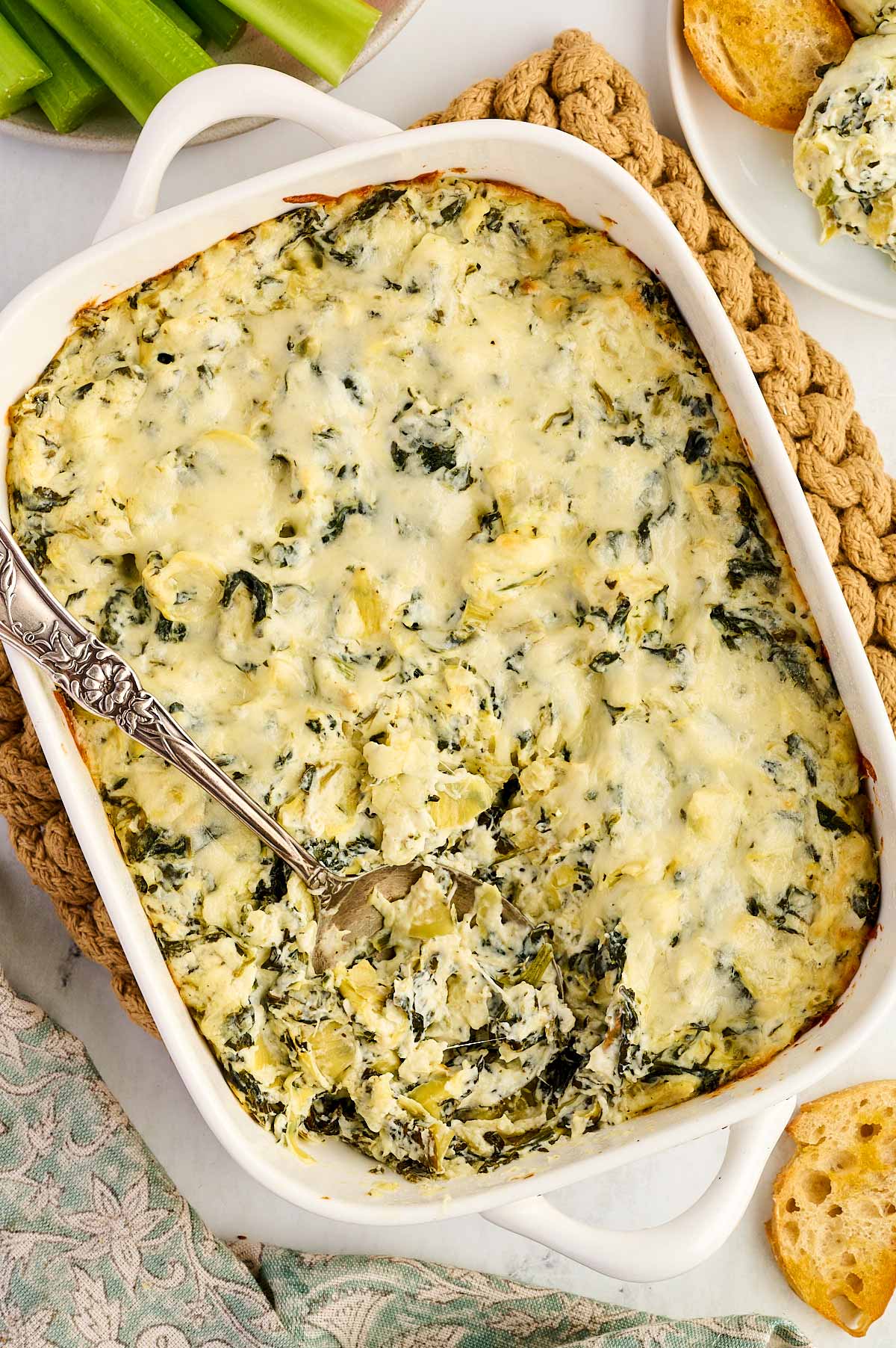 A dish with spinach artichoke dip.