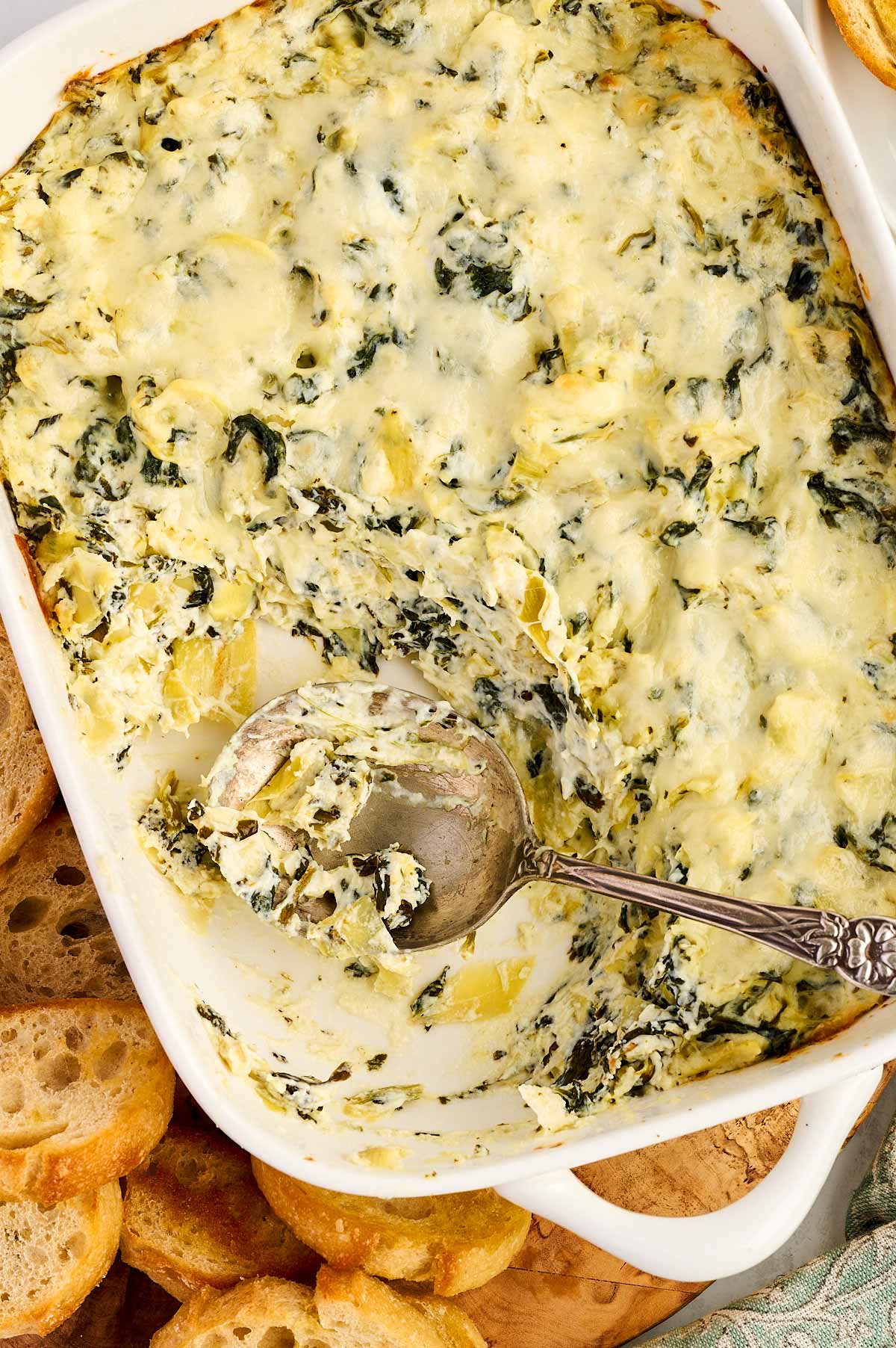 Eating spinach artichoke dip from the dish.