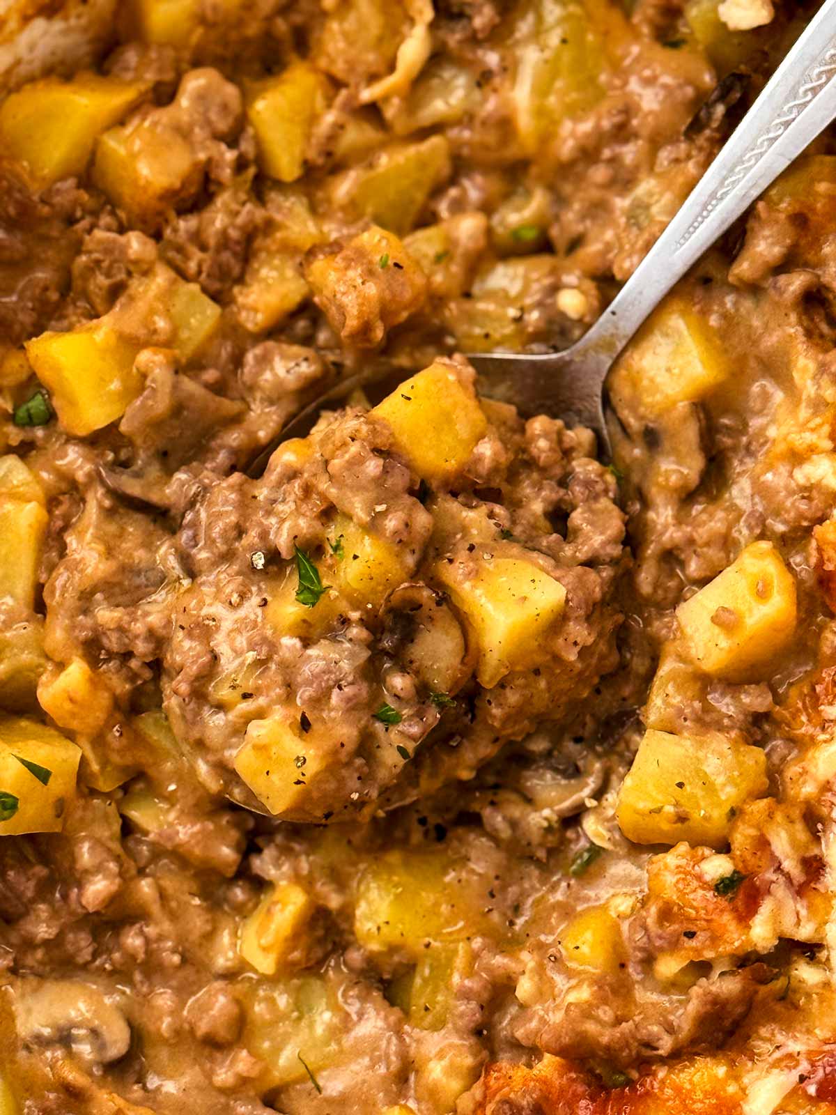 yummy cheesy ground beef and potato casserole on a spoon
