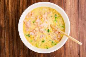 Stirring the mixture for chicken broccoli pasta casserole.
