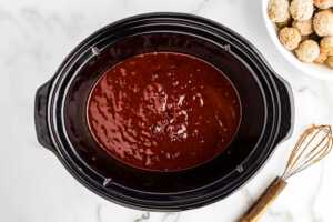 Whisking the cranberry sauce in the crock.