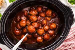 Serving cranberry meatballs.