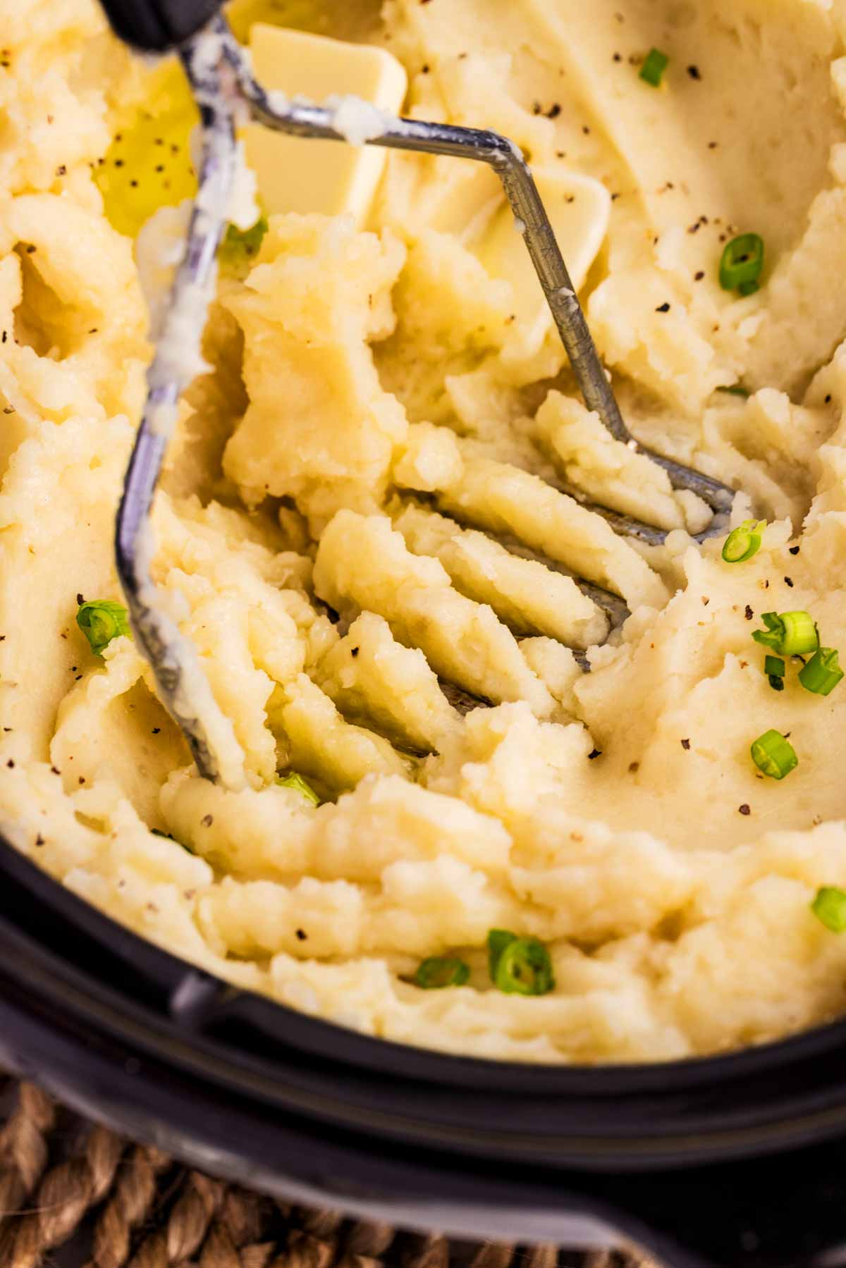 Mashing potatoes in a slow cooker.