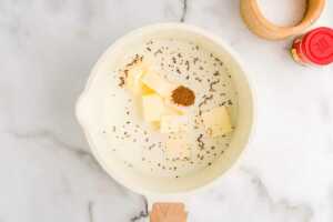 Making warmed milk for slow cooker mashed potatoes.