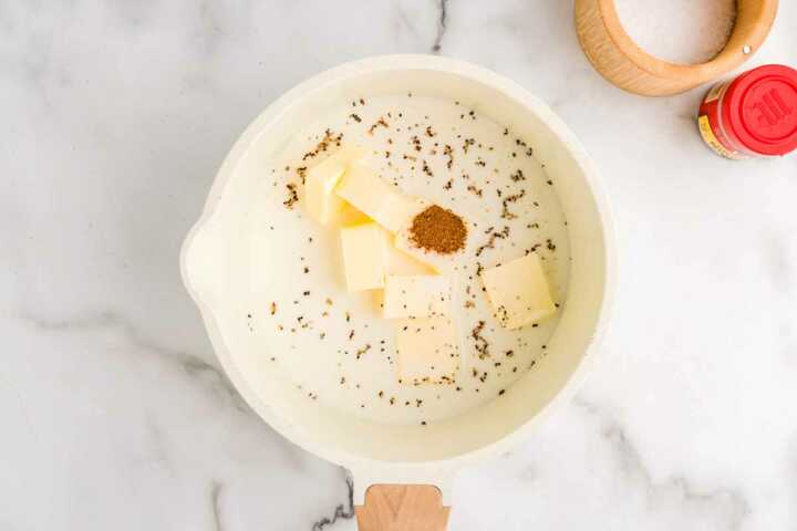 Making warmed milk for slow cooker mashed potatoes.