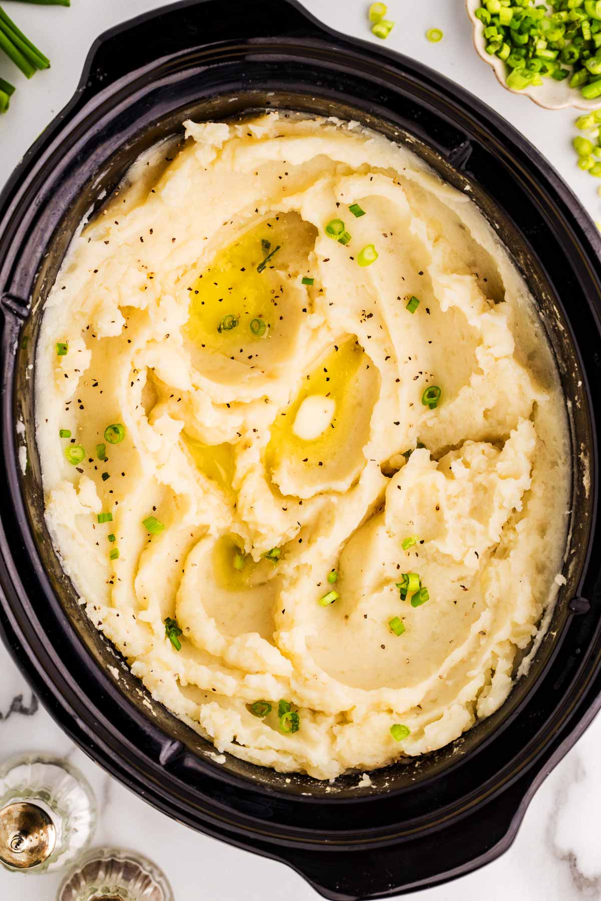Serving mashed potatoes from a slow cooker.