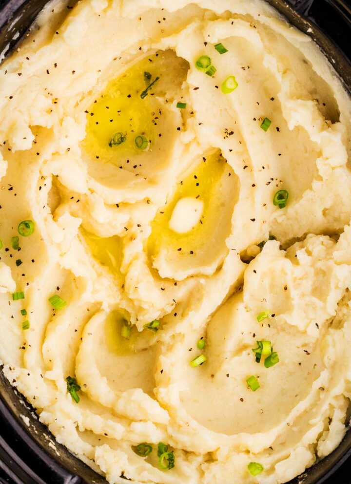 Serving mashed potatoes from a slow cooker.
