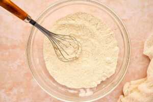 Flour mixture for banana bread whisked in a bowl.