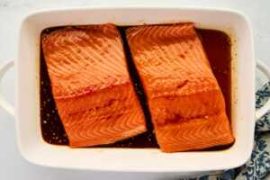 Marinating salmon in honey glaze.