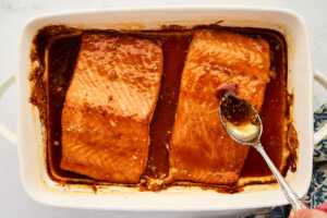 Basting salmon with honey glaze.