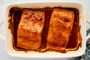 Serving honey glazed salmon in a casserole dish.