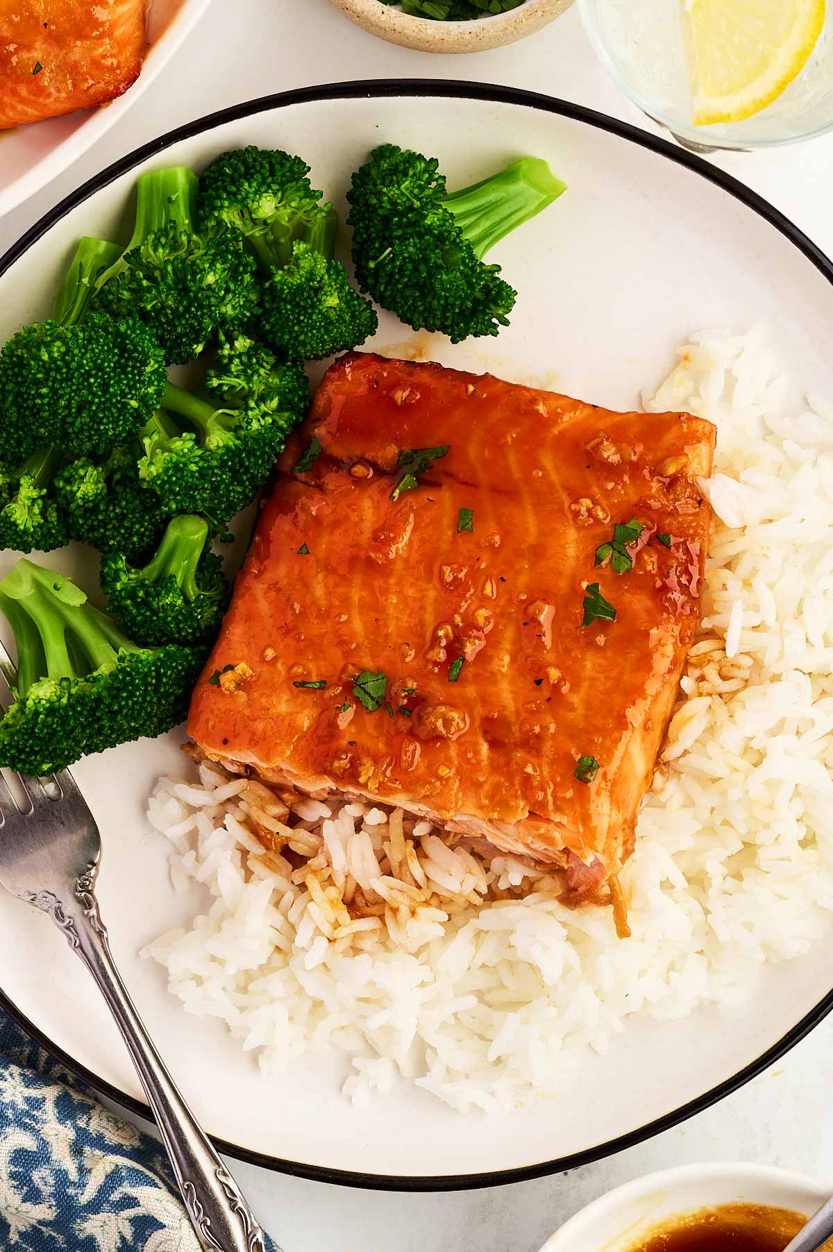 Serving salmon with rice and broccoli.