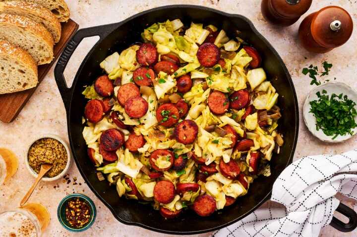 Serving kielbasa and sausage from a cast iron skillet.