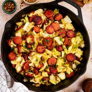 Serving kielbasa and sausage from a cast iron skillet.