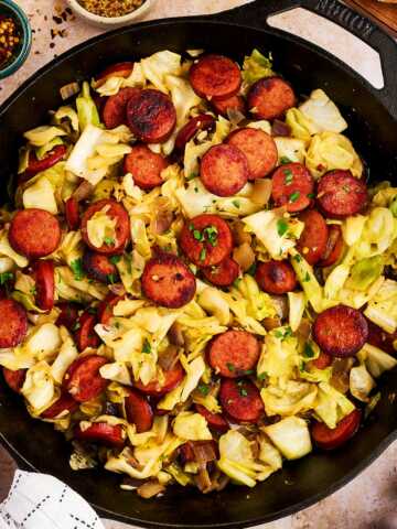 Serving kielbasa and sausage from a cast iron skillet.