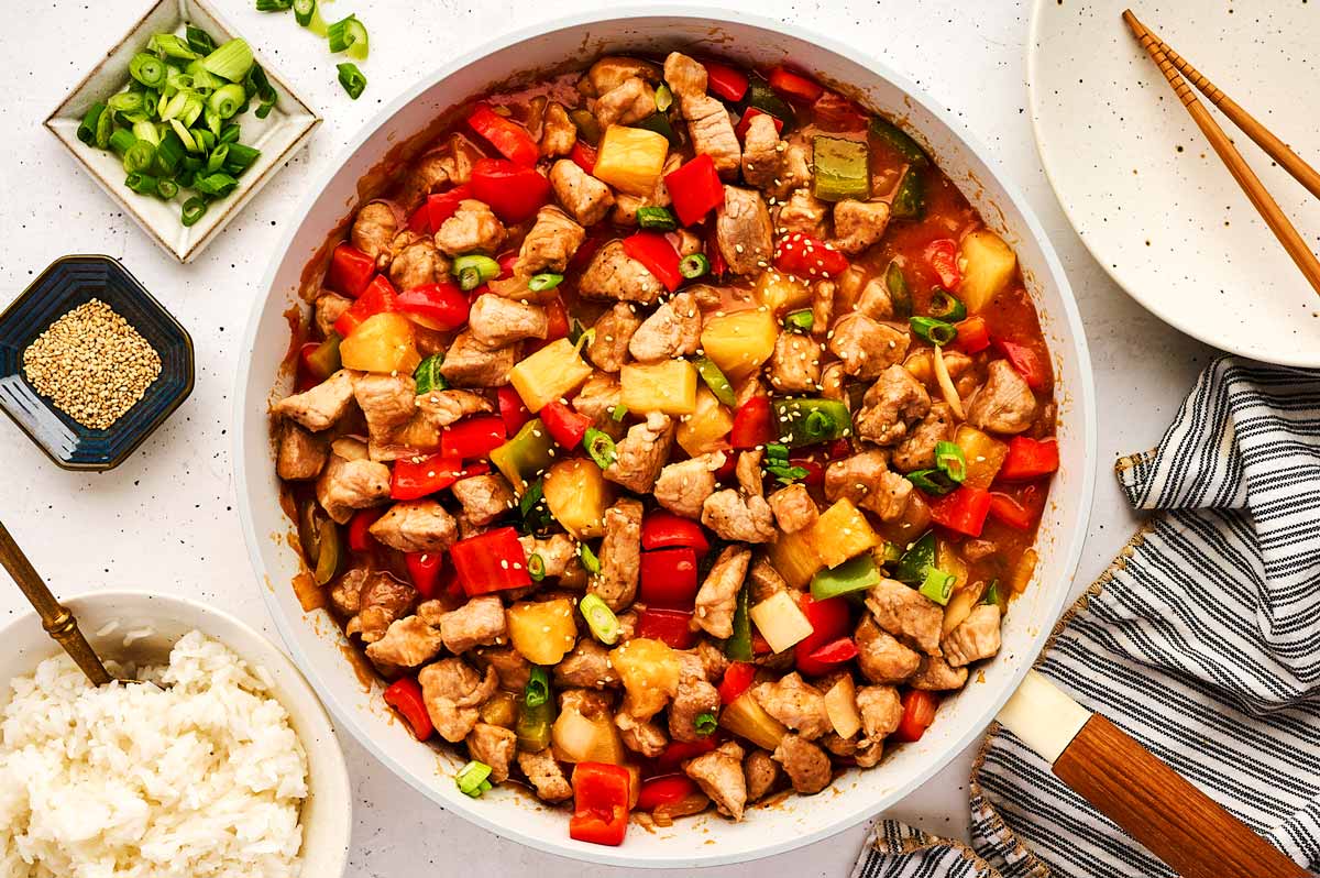 Serving sweet and sour pork in a skillet.