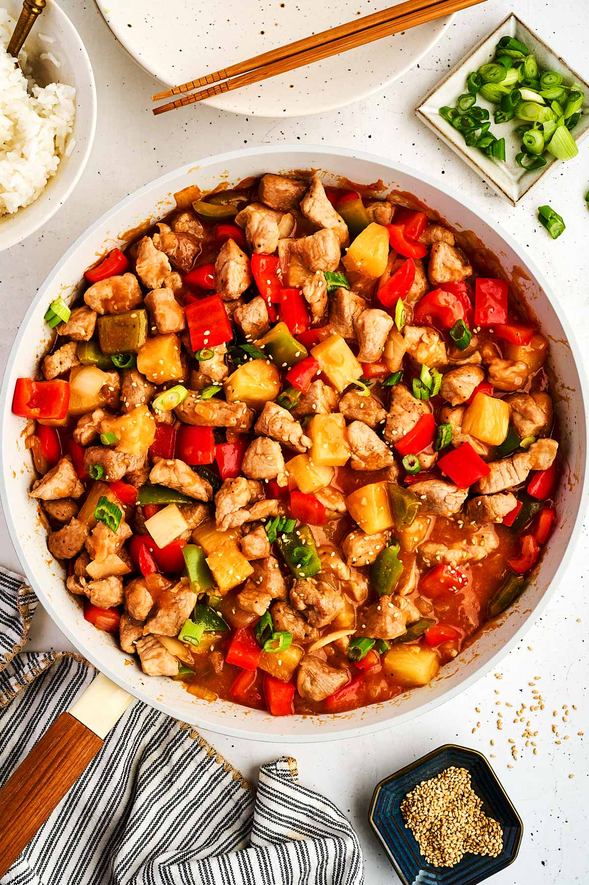 Serving sweet and sour pork in a skillet.