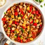 Serving sweet and sour pork in a skillet.