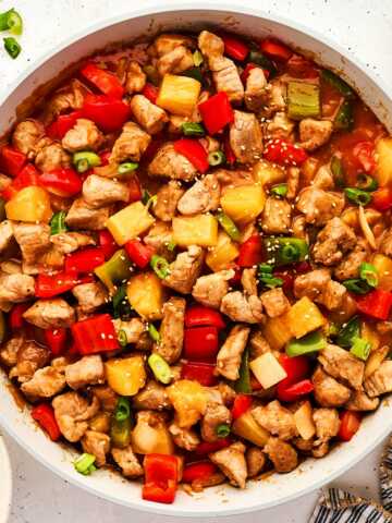 Serving sweet and sour pork in a skillet.