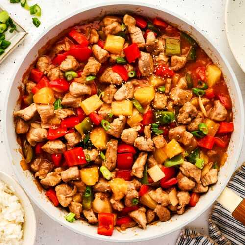 Serving sweet and sour pork in a skillet.