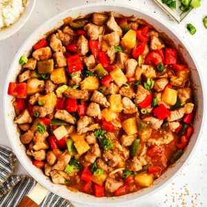 Serving sweet and sour pork in a skillet.
