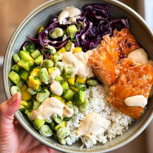 Holding a Teriyaki Salmon Bowl.