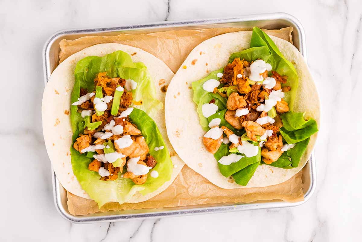 Assembling chicken wraps.