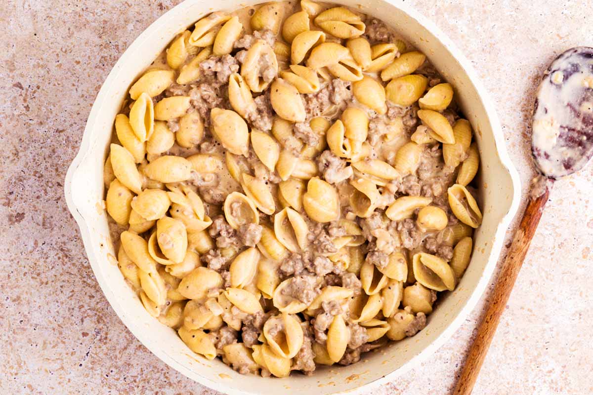 Cheesy ground beef pasta in a skillet.