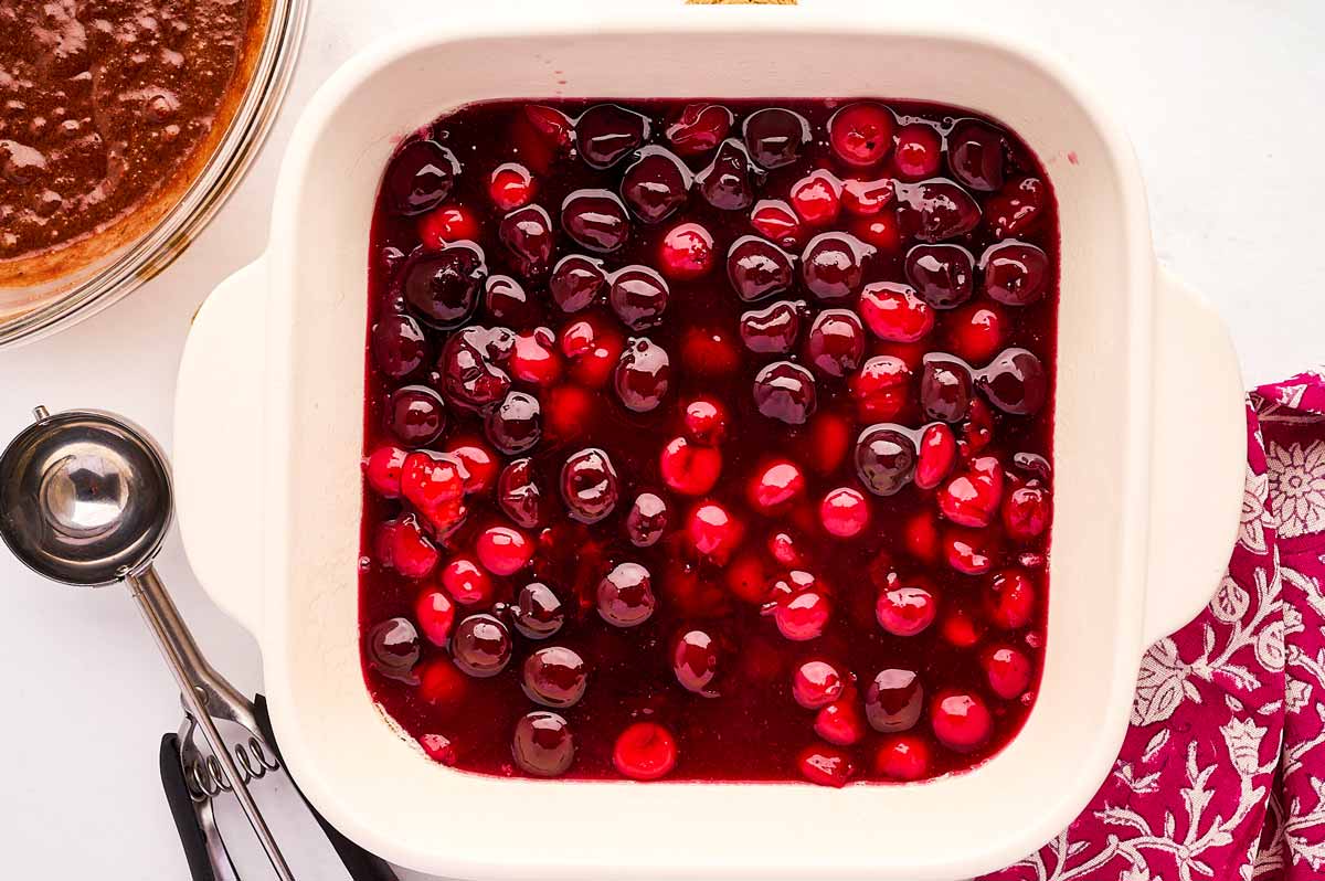 Cooling cherry pie filling in a baking dish.