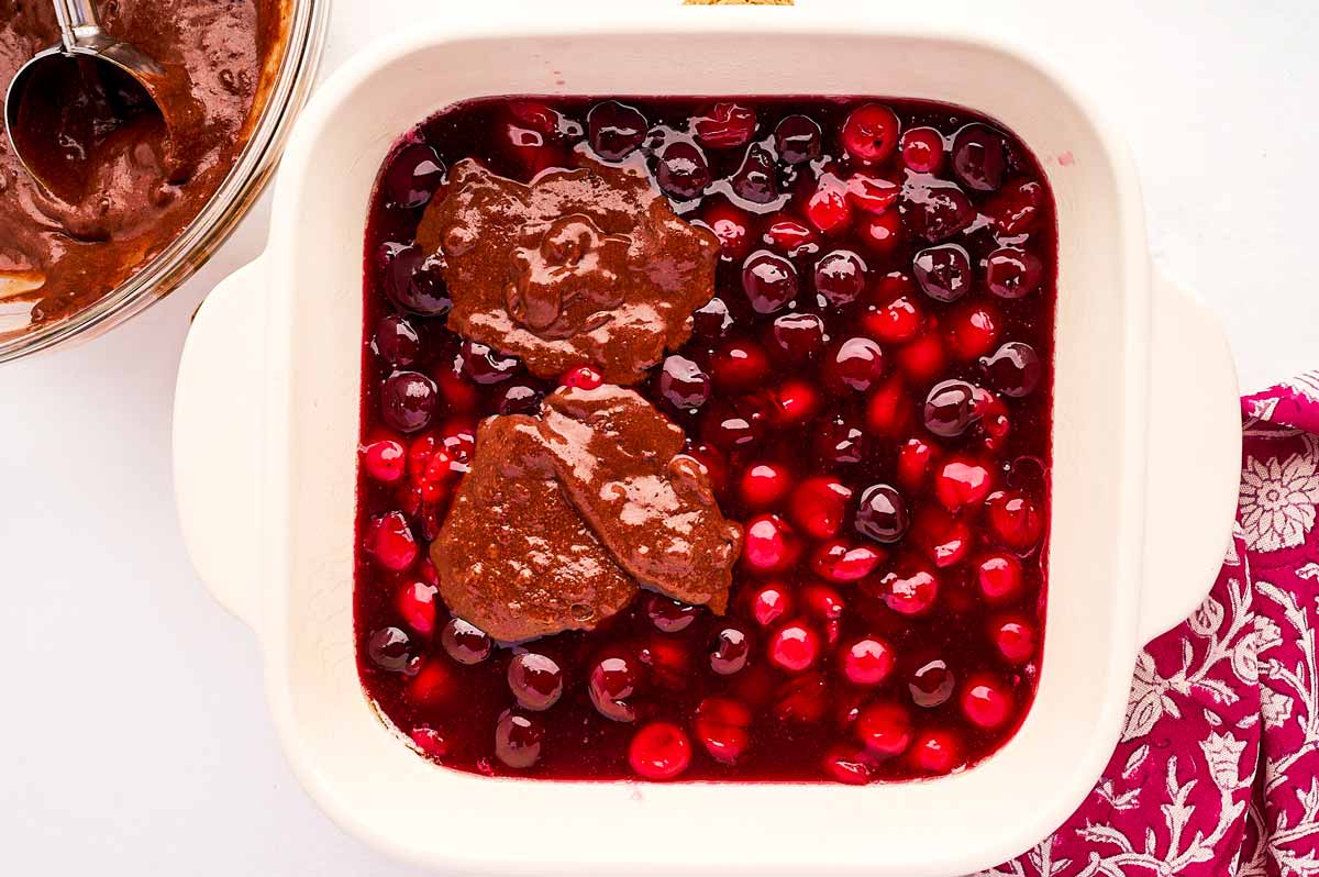 Dolloping batter on cherry filing.