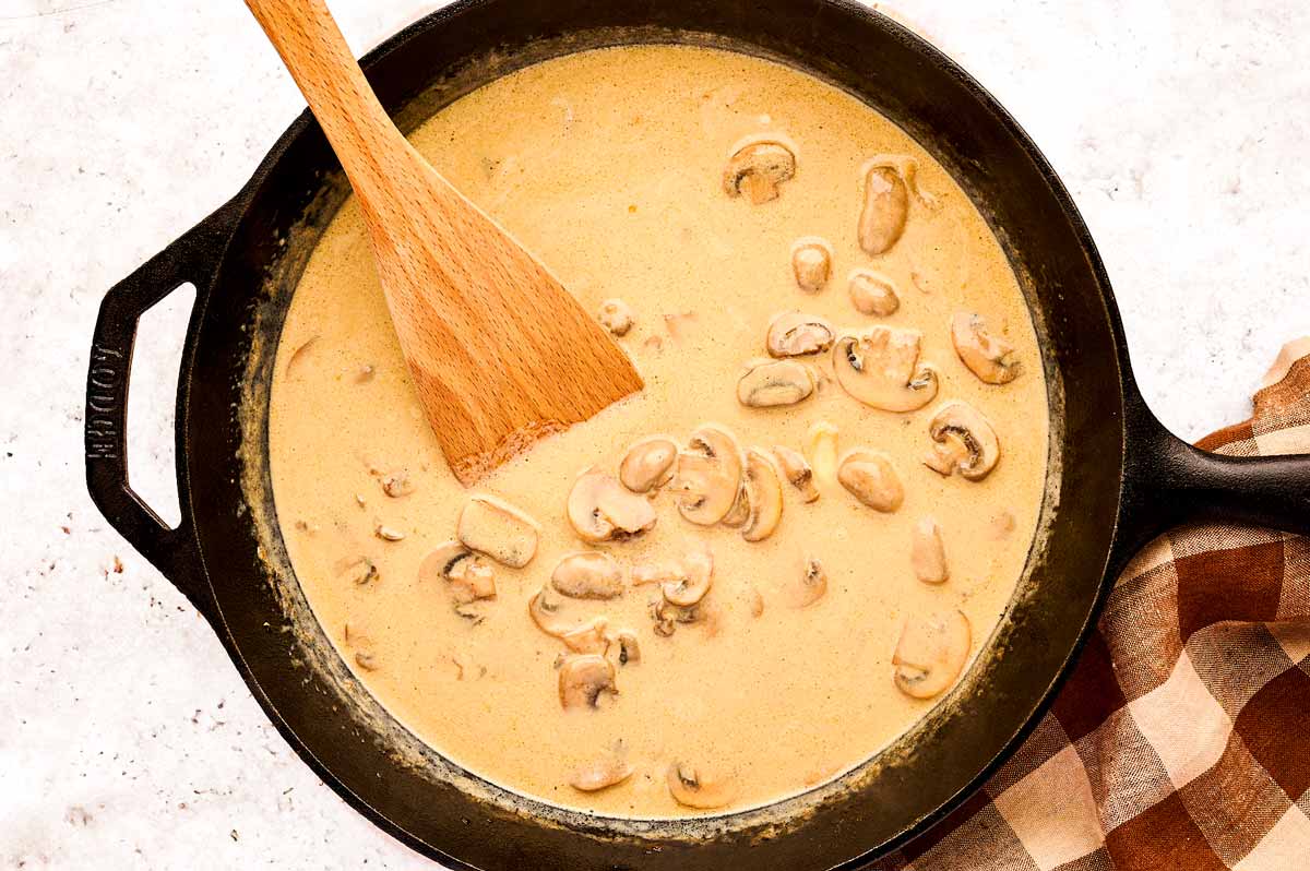 Creamy mushroom gravy in cast iron skillet.