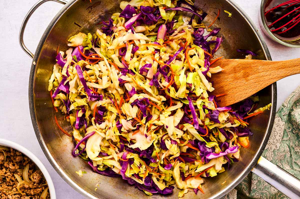 Stir-frying coleslaw mix.