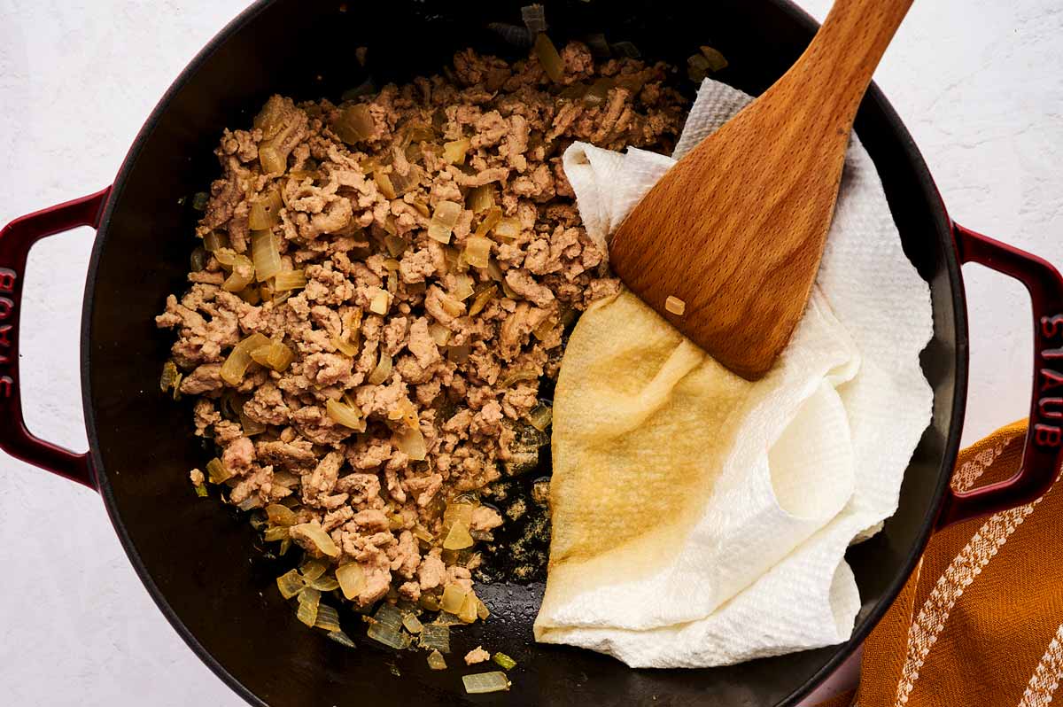 Draining browned ground turkey with paper towels.