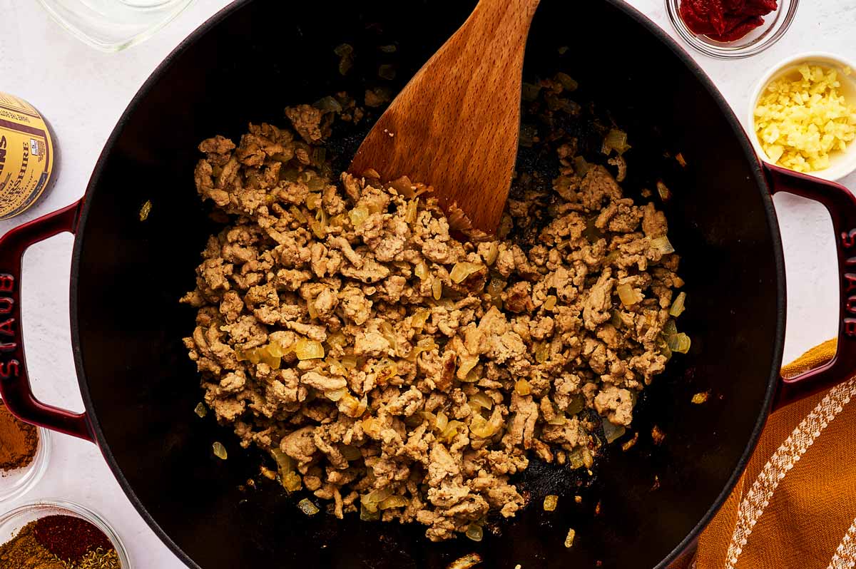 Deglazing a pot of ground turkey.