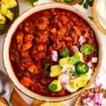Bowl of turkey chili with toppings.