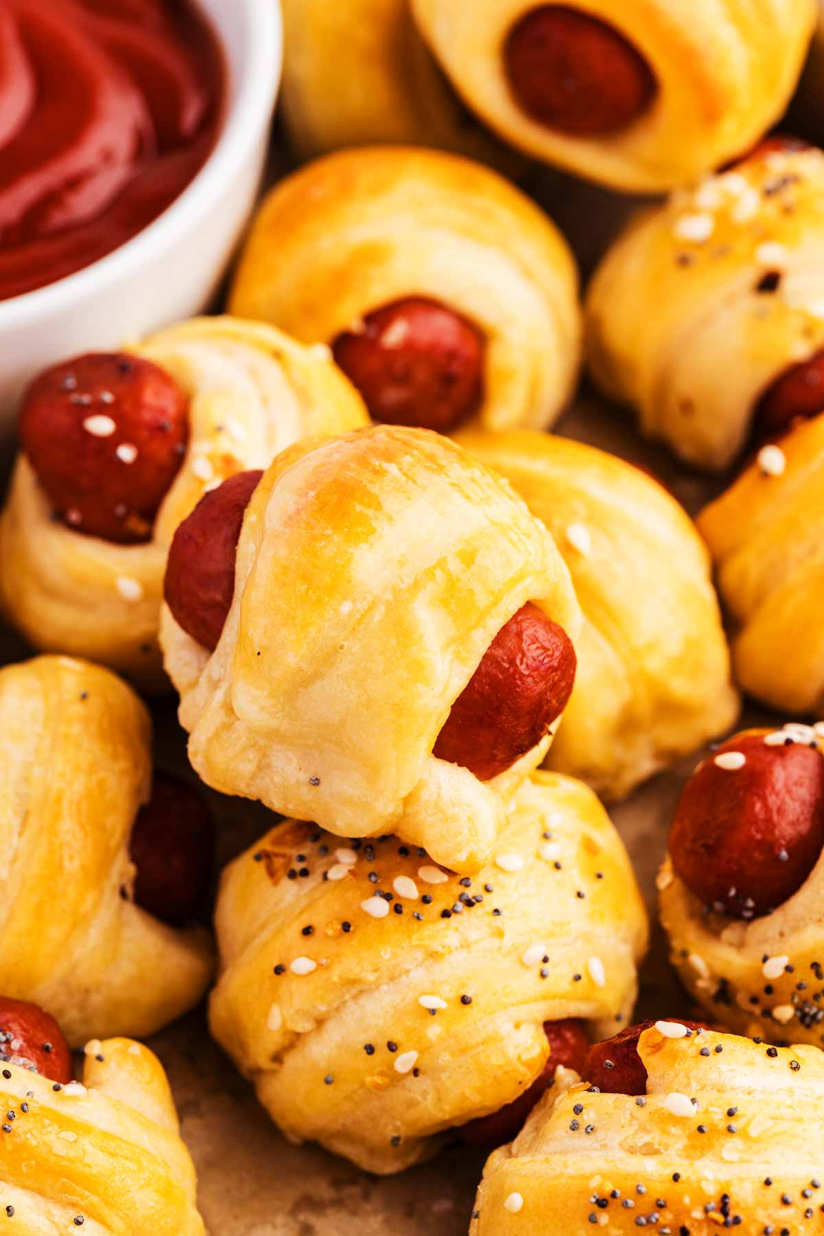 Serving pigs in blankets with ketchup.