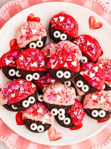 Love bug decorated Oreos on a plate.