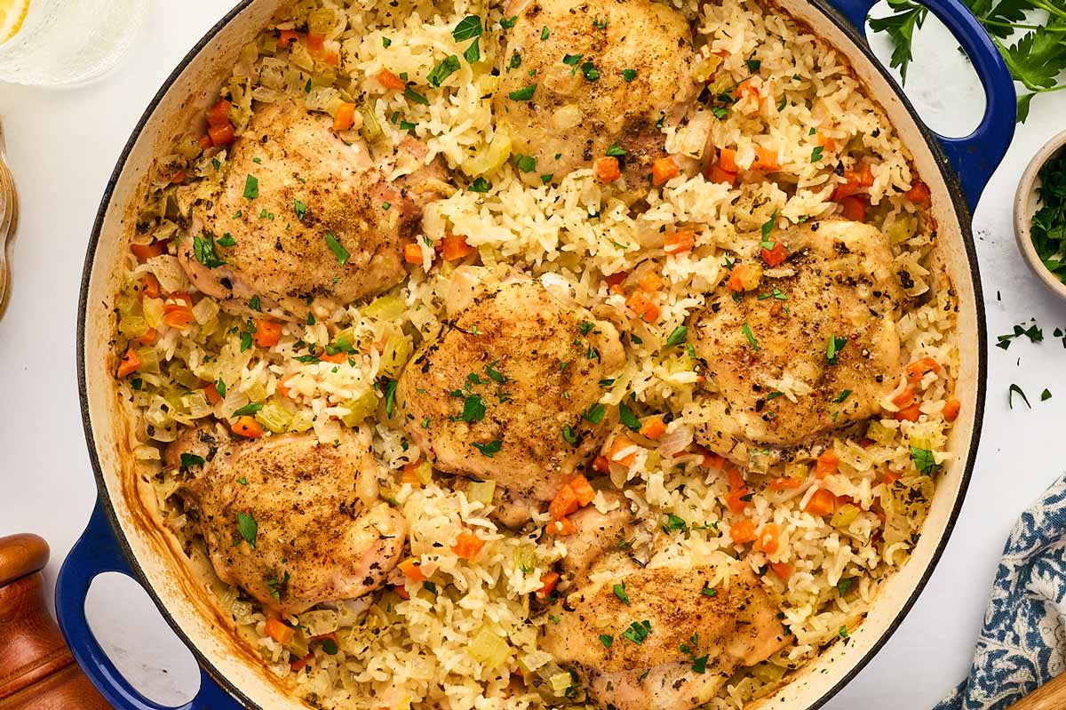 Pan with baked chicken thighs and rice.