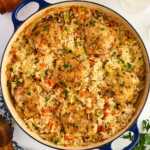 Pan with baked chicken thighs and rice.