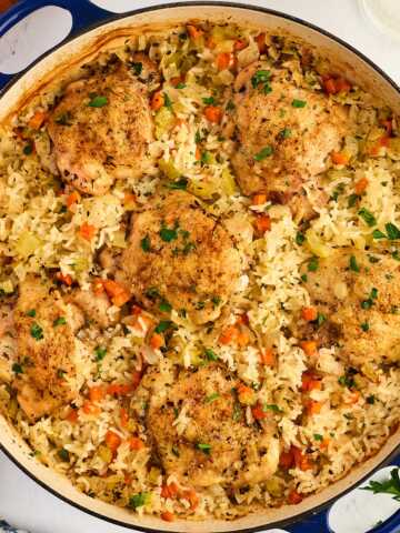 Pan with baked chicken thighs and rice.