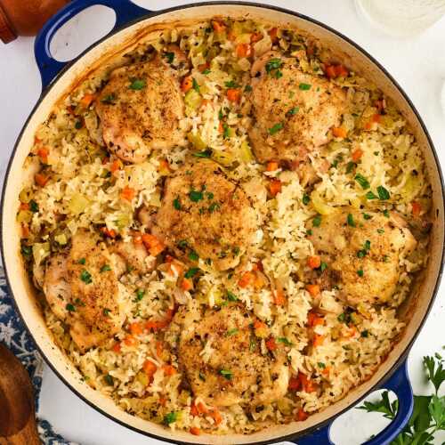 Pan with baked chicken thighs and rice.