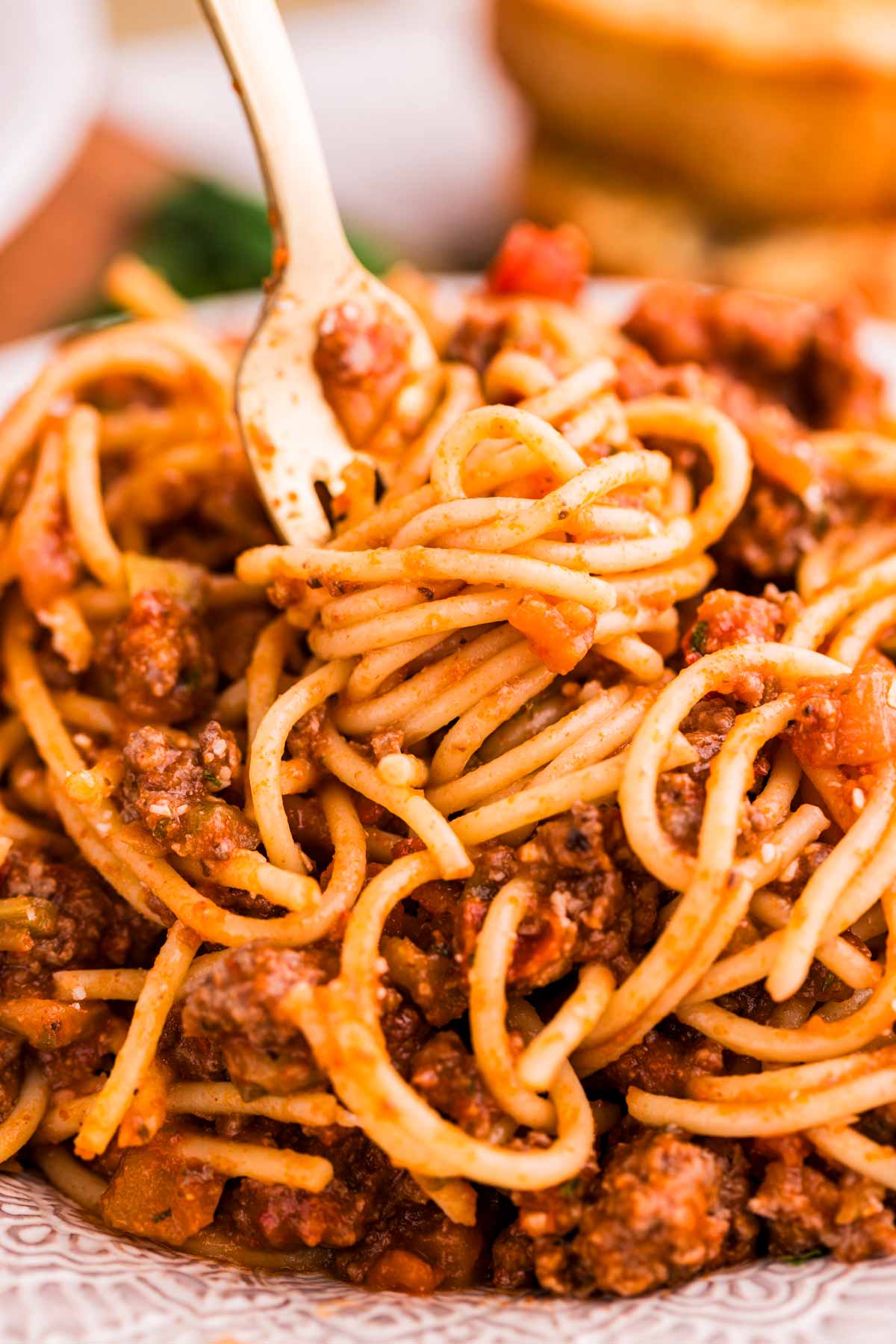 Twirled spaghetti on a fork.