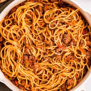 Skillet with spaghetti and meat sauce.