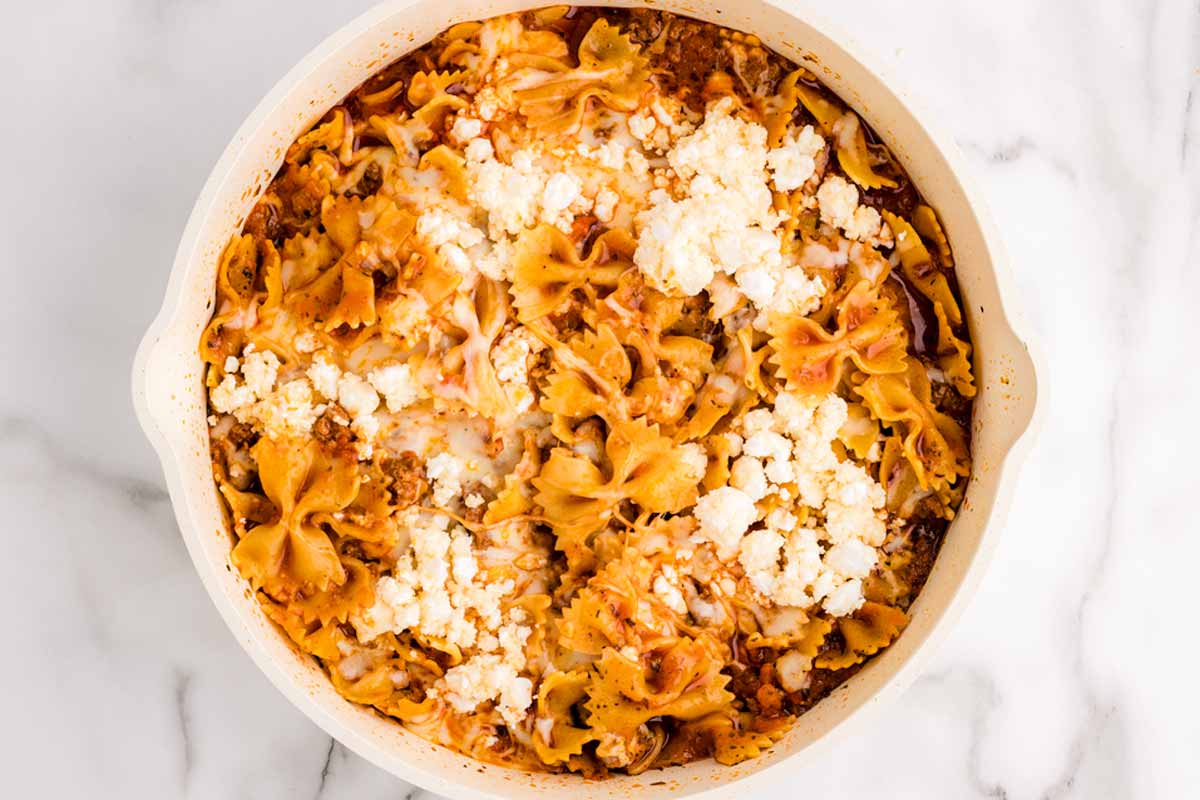 Mozzarella and ricotta on top of skillet lasagna.